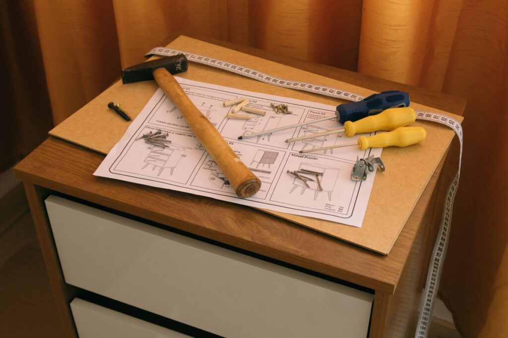 Furniture assembly with a hammer, screwdriver and instructions