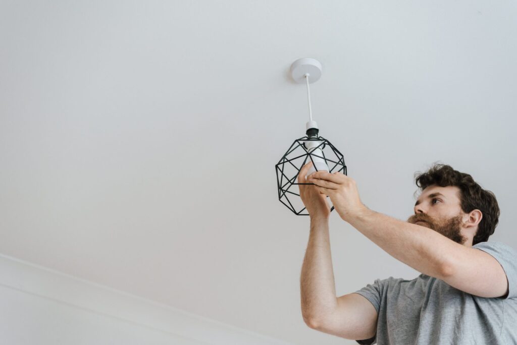 Man installing a pendant light fixture